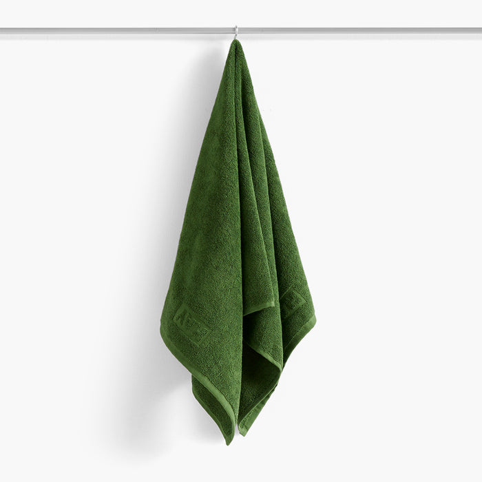 The Mono Hand Towel in Matcha Green  form HAY feature a classic, timeless design with an embossed HAY logo.Crafted from durable OEKO-TEX® cotton with a super soft terry texture,The Mono guest towels come in vibrant solid colors that match with the CHECK bath mats and towels from HAY.