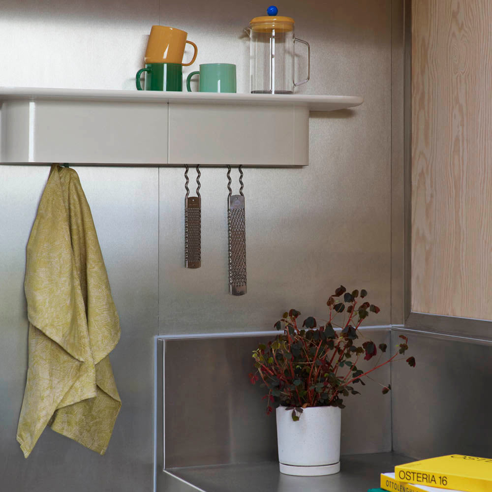 The Korpus Shelf from HAY is a smart multi-purpose shelf made from lightweight and strong sheet aluminium. This wall-mounted shelf has practical concealed hooks for different hanging possibilities. 