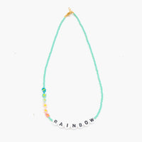 The RAINBOW Necklace from French label Bbuble is a chic and colorful necklace made from aqua colored miyuki beads and white letter beads. Six small multi-color daisies are nicely arranged around the RAINBOW beads. All bracelets from Bbuble are handmade in their Parisian workshop. 