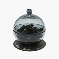 A diffuser set in smoky black mouth-blown glass with charcoal inside 
