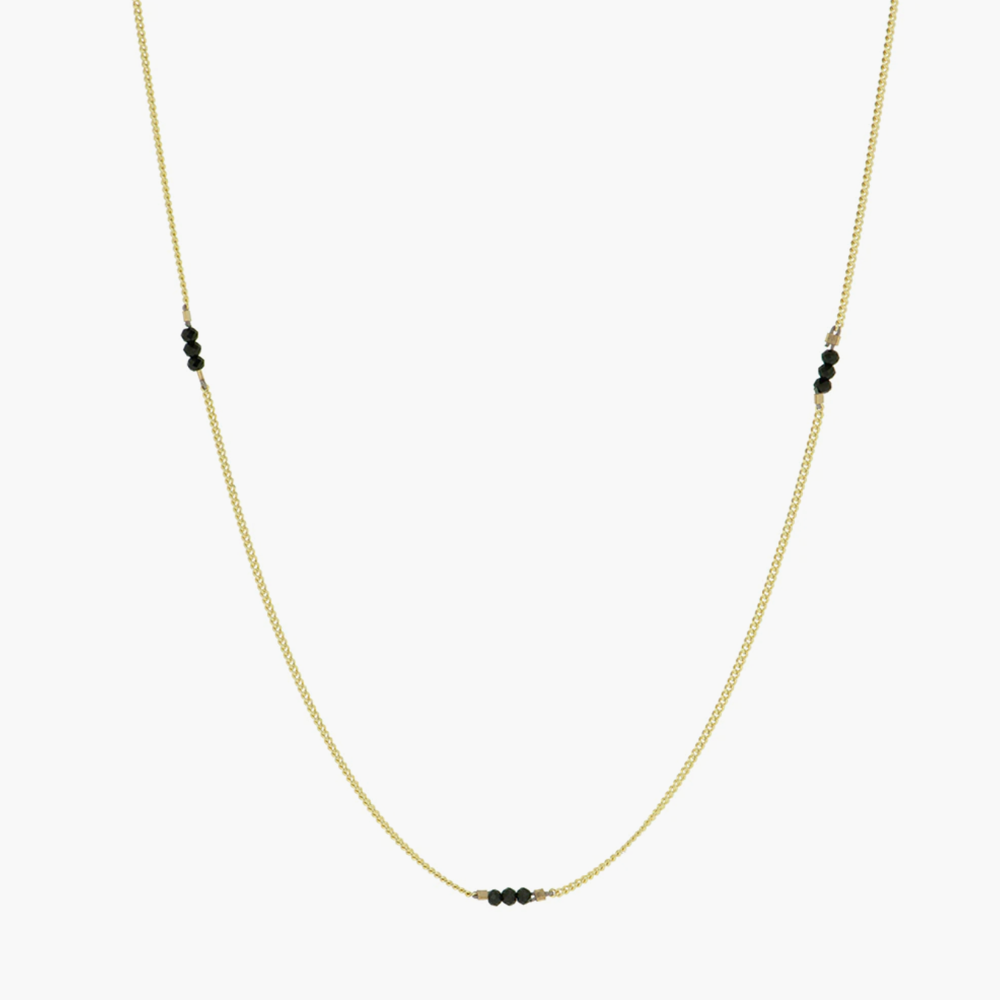 A delicate and elegant gold necklace, from BY1OAK, strung with clusters of onyx stones. A never take off type of necklace.