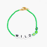 The WILD Bracelet from French label Bbuble is a chic and colorful bracelet made from grass green miyuki beads and white letter beads. Three small daisies in green shades are nicely arranged around the WILD beads. All bracelets from Bbuble are handmade in their Parisian workshop. 
